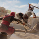 A man in a white robe and hood jumps into the air to attack someone with a sword.